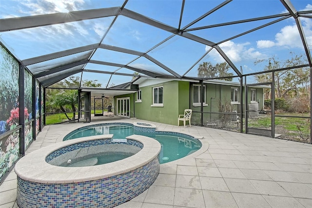 view of pool featuring glass enclosure, an in ground hot tub, and a patio area