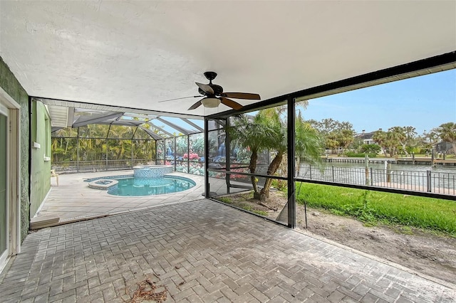 exterior space featuring ceiling fan, a swimming pool, and a water view