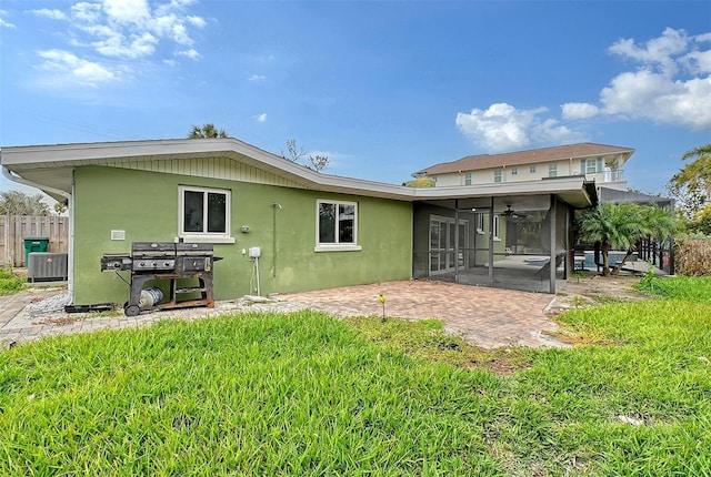 rear view of house with a lawn, ceiling fan, and a patio