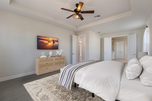 bedroom featuring ceiling fan and a tray ceiling