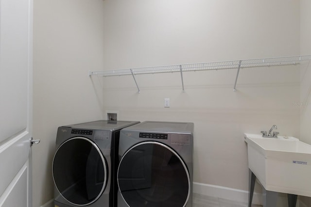 laundry area with sink and washer and dryer