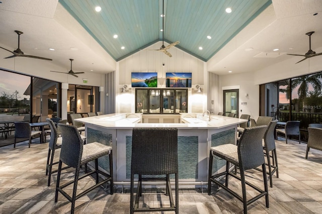 bar with high vaulted ceiling and ceiling fan