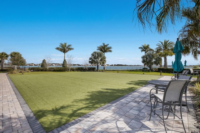 view of yard with a patio and a water view