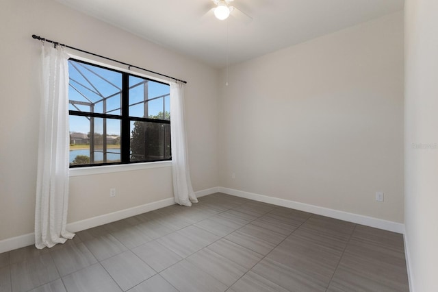 tiled spare room with a water view