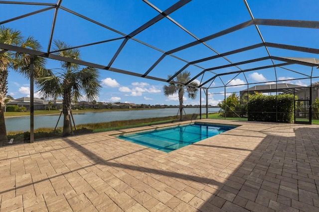 view of swimming pool featuring a patio, a water view, and glass enclosure