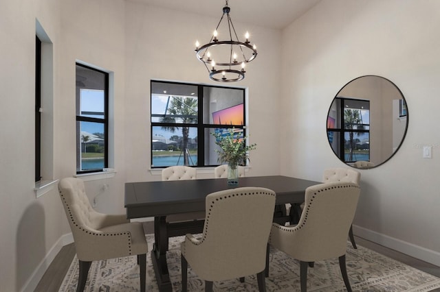 dining area featuring hardwood / wood-style floors and a chandelier