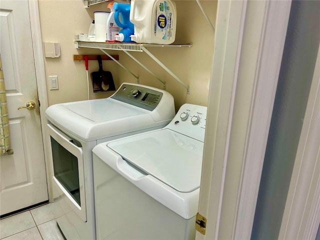 clothes washing area featuring independent washer and dryer and light tile patterned flooring