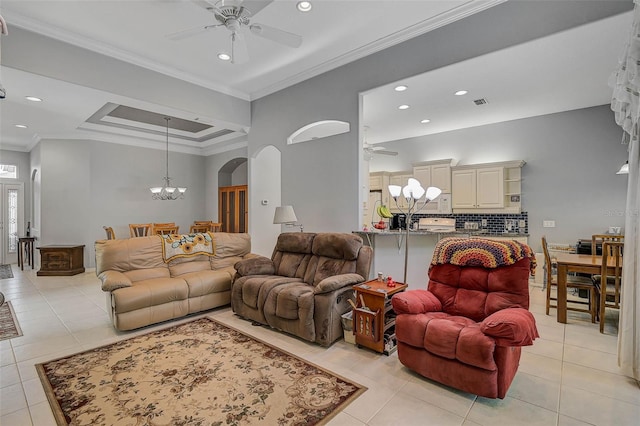 tiled living room with crown molding and ceiling fan with notable chandelier