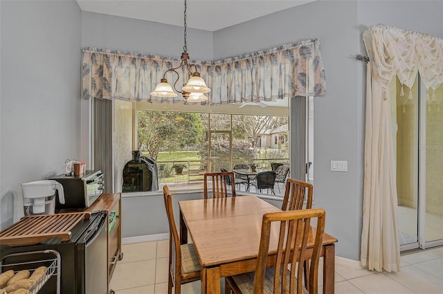 tiled dining space featuring a notable chandelier