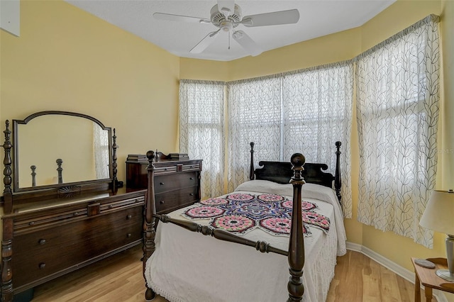 bedroom with ceiling fan and light hardwood / wood-style flooring