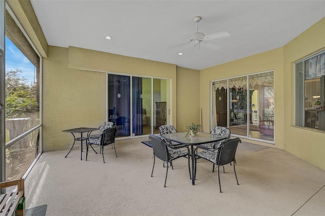 sunroom / solarium featuring ceiling fan