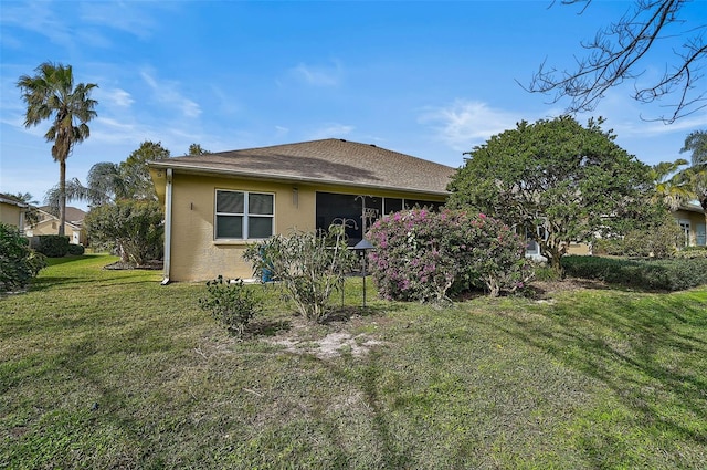 rear view of house featuring a yard