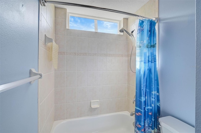 bathroom with toilet and shower / bath combo with shower curtain