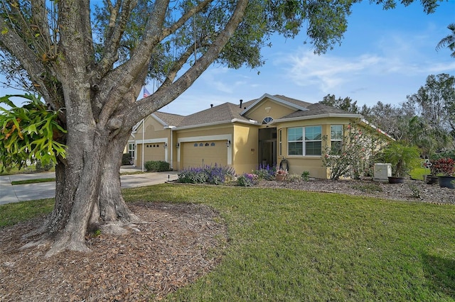 ranch-style home with a garage and a front yard