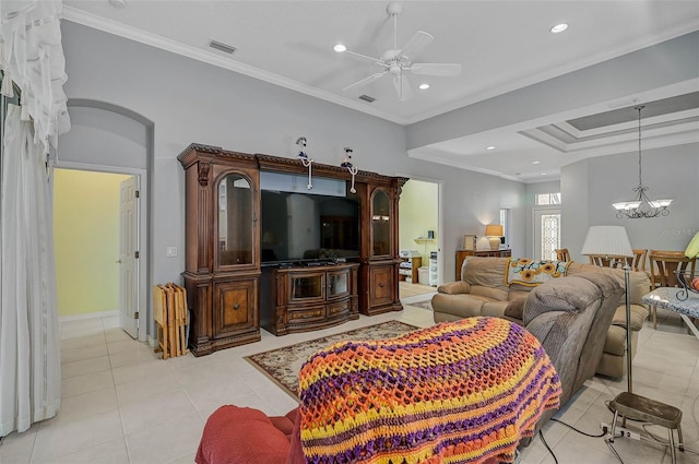 tiled living room featuring ceiling fan with notable chandelier and ornamental molding