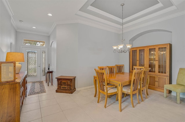 tiled dining area featuring a notable chandelier, crown molding, and a raised ceiling