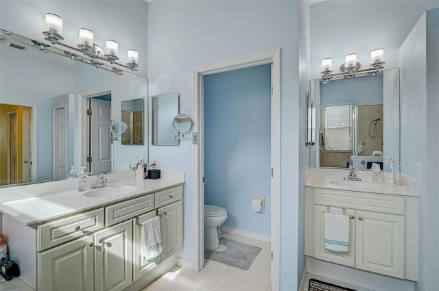 bathroom with vanity, tile patterned floors, toilet, and tiled shower