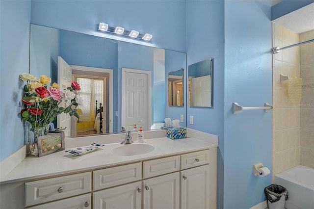 bathroom featuring vanity and tiled shower / bath