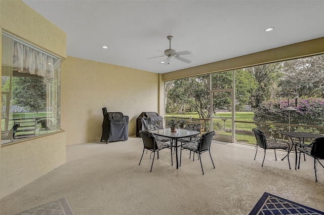 sunroom / solarium featuring ceiling fan