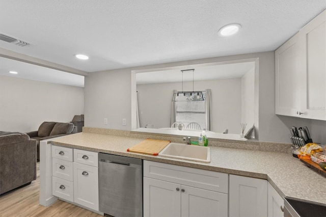 kitchen with white cabinets, dishwasher, decorative light fixtures, sink, and kitchen peninsula