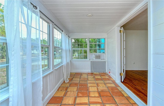 unfurnished sunroom with plenty of natural light and cooling unit