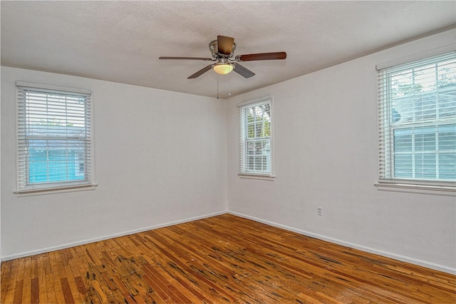 unfurnished room featuring ceiling fan, hardwood / wood-style floors, and a textured ceiling