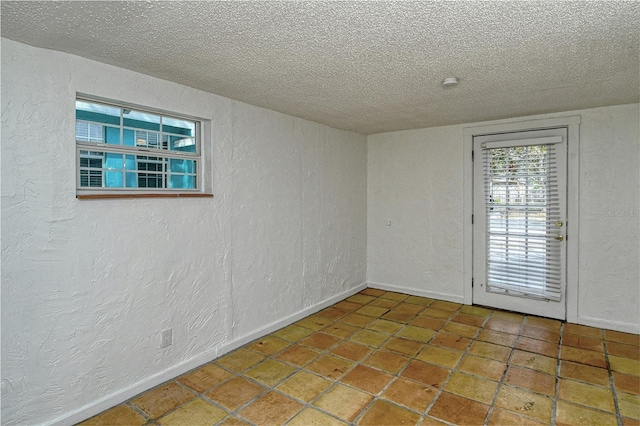 empty room featuring a textured ceiling