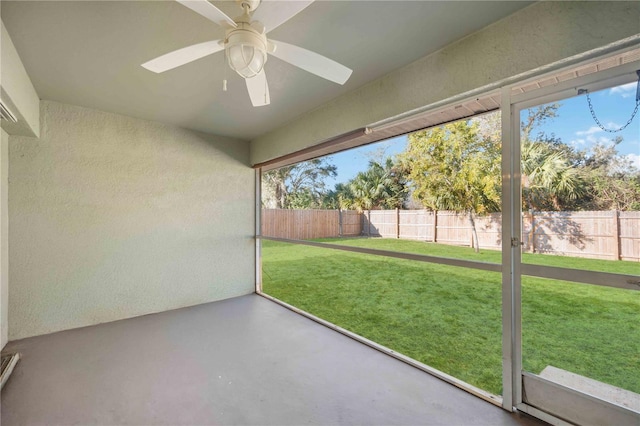 unfurnished sunroom featuring ceiling fan