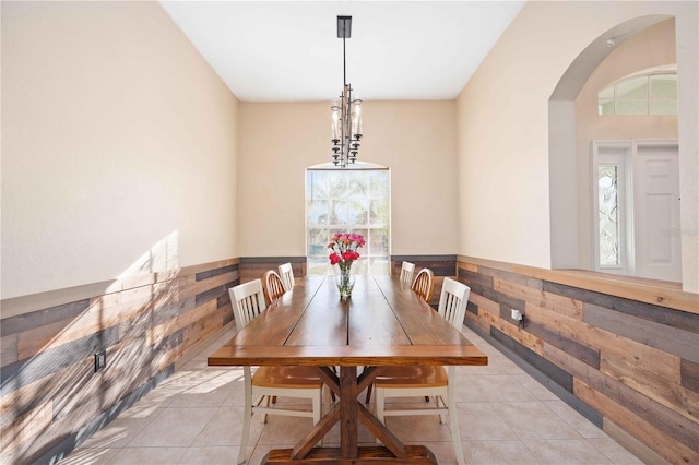 tiled dining area with wood walls