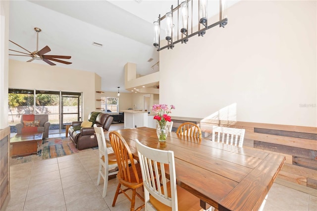 tiled dining room featuring high vaulted ceiling and ceiling fan