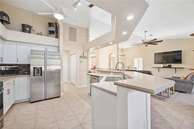 kitchen with ceiling fan, stainless steel appliances, sink, and white cabinets