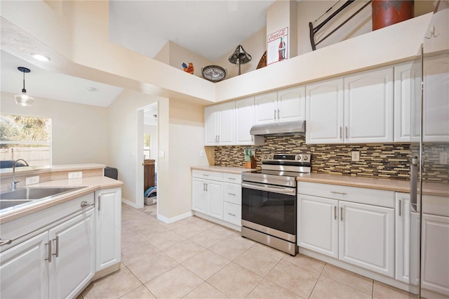 kitchen with pendant lighting, tasteful backsplash, stainless steel range with electric cooktop, and white cabinets