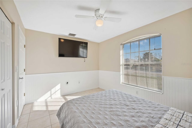 bedroom featuring light tile patterned floors and ceiling fan