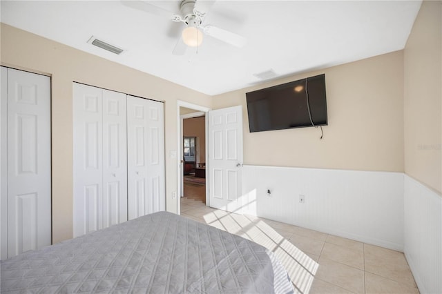 tiled bedroom with ceiling fan