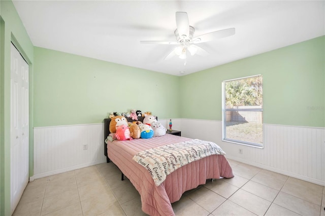 bedroom featuring a closet, ceiling fan, and light tile patterned flooring