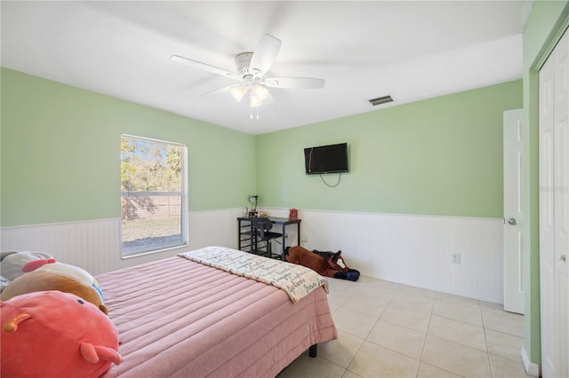 bedroom with ceiling fan and light tile patterned flooring