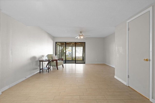 unfurnished room with a ceiling fan, baseboards, and light wood finished floors