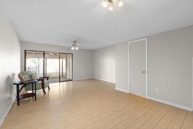 unfurnished room with light wood-type flooring, ceiling fan, and baseboards