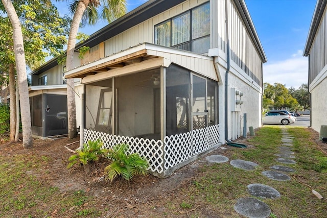 view of property exterior with a sunroom