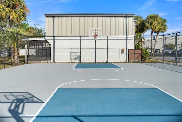 view of basketball court with community basketball court and fence