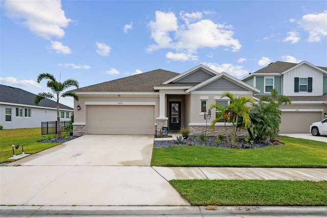 view of front of home with a front yard and a garage