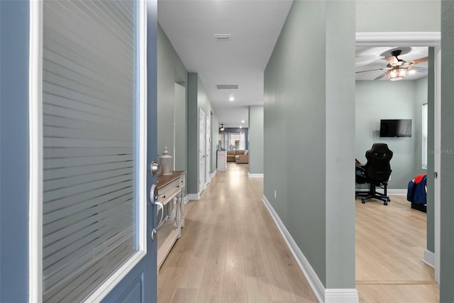 corridor with light hardwood / wood-style flooring