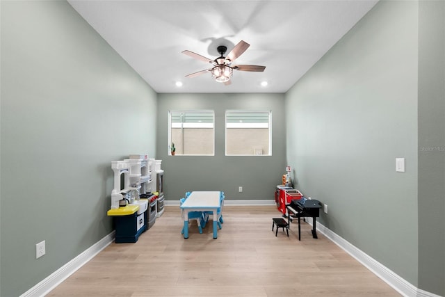 recreation room with light hardwood / wood-style flooring and ceiling fan