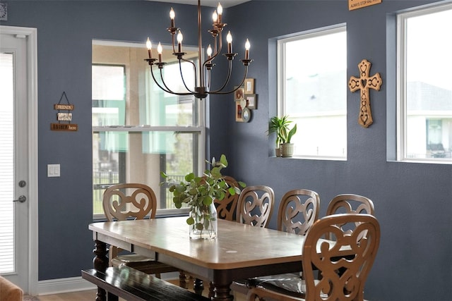 dining area featuring a wealth of natural light and a notable chandelier