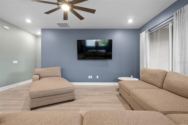 living room featuring ceiling fan and light hardwood / wood-style flooring