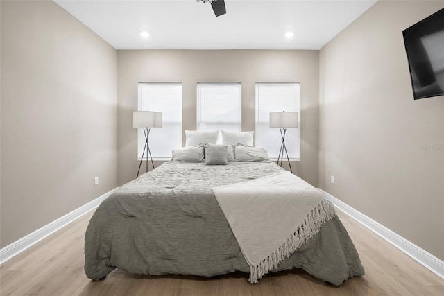 bedroom with ceiling fan and light hardwood / wood-style floors