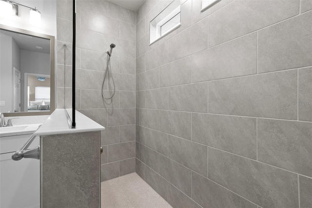 bathroom featuring vanity and a tile shower