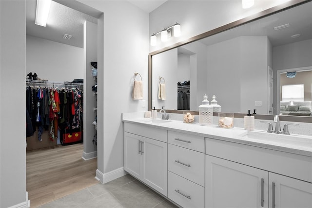 bathroom featuring vanity, tile patterned flooring, and a textured ceiling