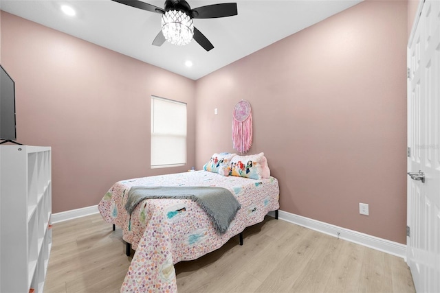 bedroom with ceiling fan and light wood-type flooring