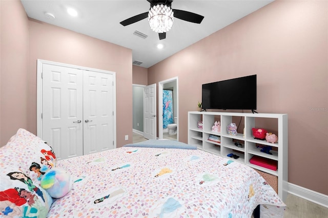 bedroom featuring connected bathroom, hardwood / wood-style floors, a closet, and ceiling fan